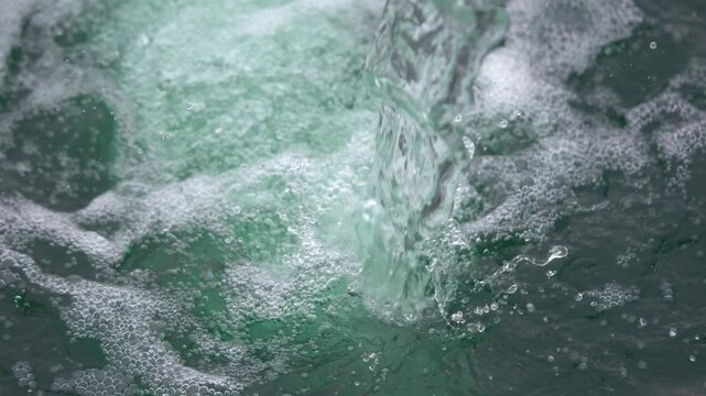 Water splashing and swirling in a dark sauna environment