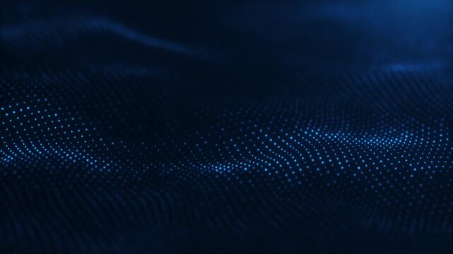 Blue particle waves form a layered digital landscape with soft depth of field on a dark navy background. Seamless loop for technology visuals.