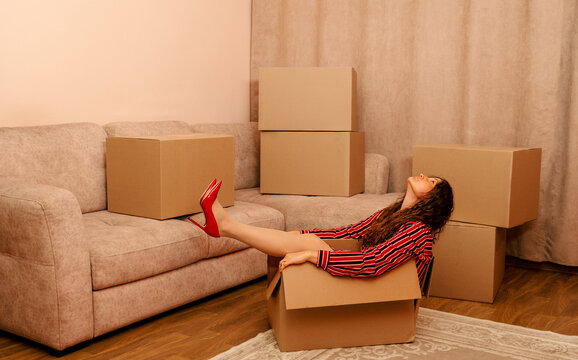 Tired woman experiences burnout inside a cardboard box