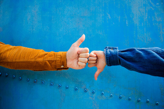 Man and woman show opposite gestures on a blue ship