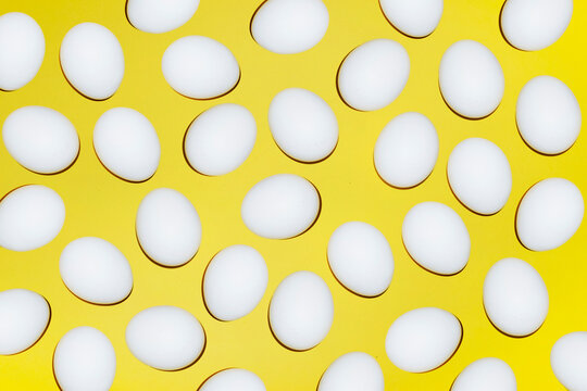 A white egg pattern covers the bright yellow background