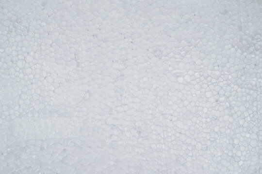 Close up view of white expanded polystyrene foam block showing cellular granular texture suitable for packaging, insulation, or craft backdrop