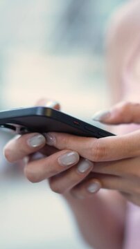 woman holds smart phone in her hands and scrolls through the news feed. Close up of hand uses mobile. point finger on screen, texting text message.