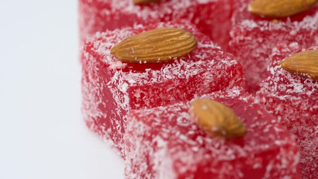 Assorted colorful Turkish delight sweets with nuts and coconut flakes rotating slowly close up. Rahat Lokum	
