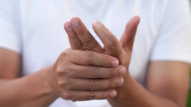 Closeup man holds his wrist. hand injury, feeling pain. Health care and medical concept. and those with a family history of degenerative knuckles.