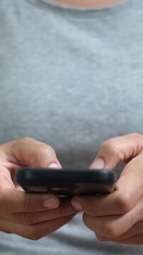 woman holds smart phone in her hands and scrolls through the news feed. Close up of hand uses mobile. point finger on screen, texting text message.