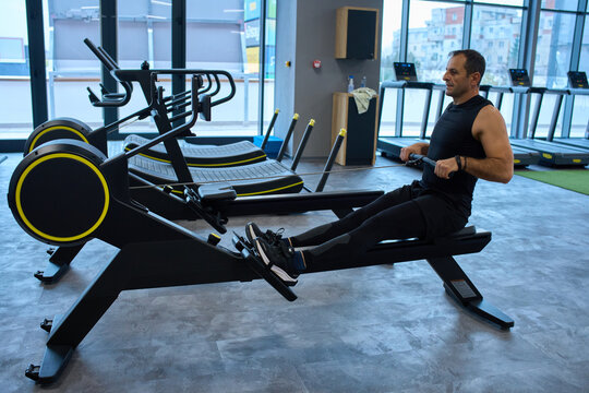 Man exercising on rowing machine