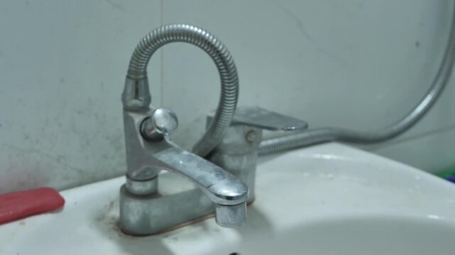Rusted household faucets with limescale buildup Iron-contaminated tap water