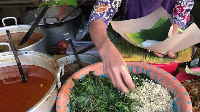 Traditional Javanese Pecel Vendor Selling Vegetables with Peanut Sauce at Market Stall
