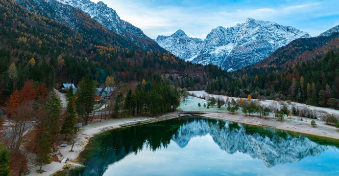 The Jasna lake with beautiful reflections of the mountains. Triglav National Park, Slovenia mountain village environs, grassy hills. Picturesque traveling