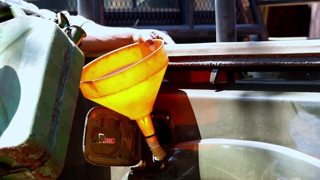 Diesel transferred by funnel as expensive energy increases transport costs