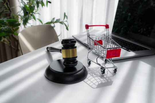 Gavel, shopping cart and laptop illustrate online retail law, ecommerce regulation, consumer rights, digital commerce compliance, marketplace transactions and legal disputes in modern shopping.