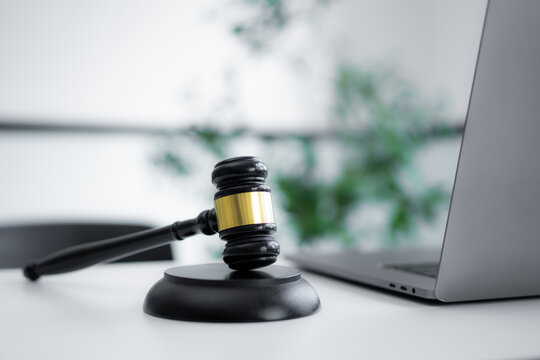 Close view of judge gavel with laptop represents cyber law, technology regulation, digital justice, online legal practice, data compliance, internet disputes and modern corporate legislation.