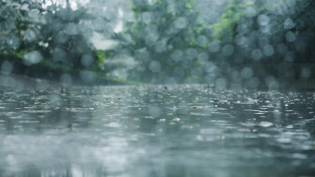 Raindrops falls behind glass while a mini car drives by