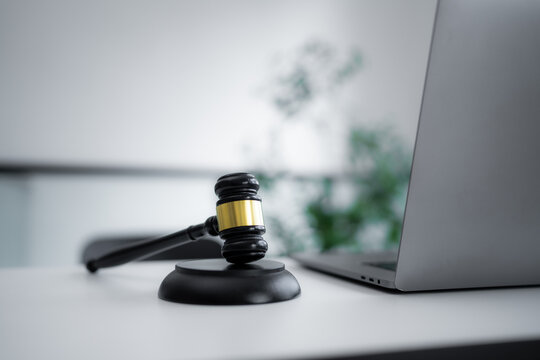 Judge gavel beside a laptop represents digital law, legal technology, online justice, cyber regulation, electronic litigation, business compliance and modern internet legal services.