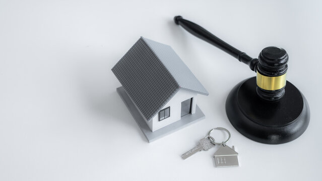Judge gavel, house model and home key symbolize property law, real estate ownership, legal protection, housing rights, mortgage agreements and residential property transactions.