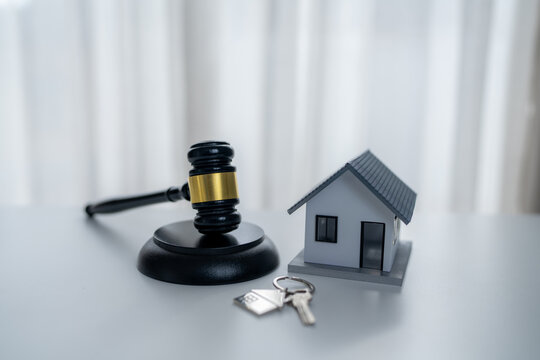 House model with judge gavel and keys symbolizes mortgage law, foreclosure, property disputes, home ownership, real estate contracts, housing rights and legal protection.
