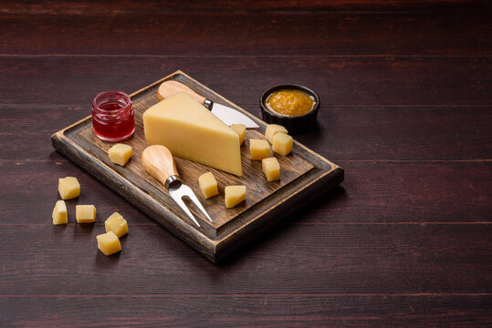Hard aged Parmesan cheese in blocks and cubes for home cooking. Parmesan cheese