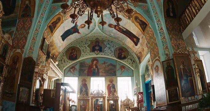 Frescoed Orthodox Church Interior with Gilded Iconostasis and Sacred Icons