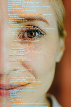 Smiling businesswoman looks at camera with digital code projection