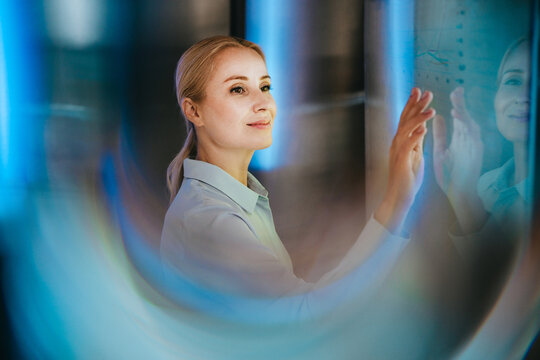 Businesswoman analyzes data on a modern digital screen