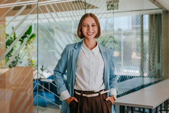 Smiling businesswoman standing in a modern office