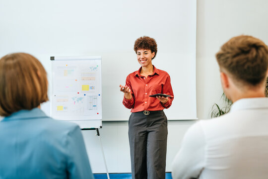 A businesswoman explains strategy during a meeting in the office