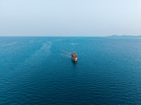 Aerial view of a fishing vessel kapal pukat sailing on the calm blue waters of the open sea in Karimunjawa, Central Java, Indonesia.
