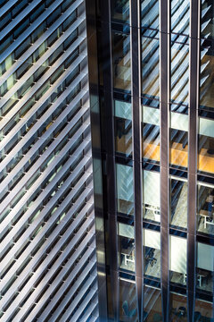 Modern architecture detail in London England with a vertical glass facade of panels lines and reflections forming an urban architecture detail