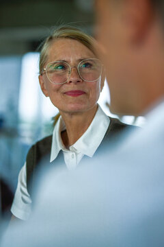 Businesswoman discusses a contract with a man in the office