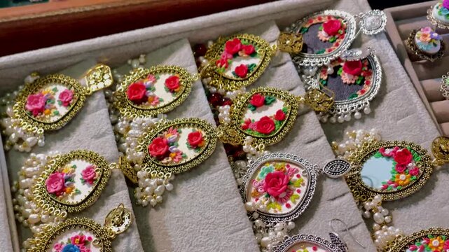 Handcrafted Floral Earrings Collection Display in Wooden Jewelry Box Tray, multi-colored ring decorations. 