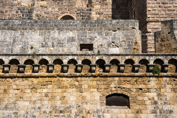 Sixteenth-century curtain wall with decorative corbels beneath the massive Swabian-era core of Bari Castle, Bari, Puglia, Italy © AlexMastro