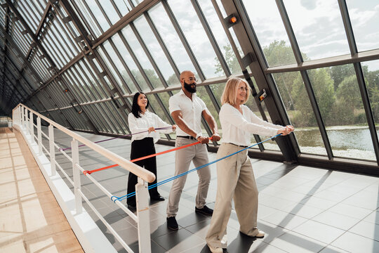 Business colleagues exercise with resistance bands