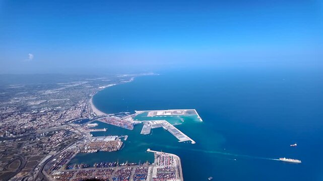 Left side cockpit view of coastal Valencia city, Malvarrosa Beach, harbor and its north coast in a splendid summer day. Captured at 2000m high.