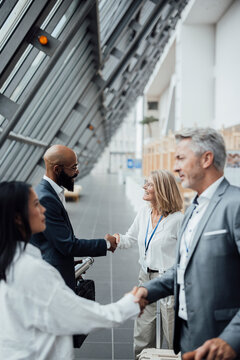 A businessman shakes hands with a partner at a trade fair