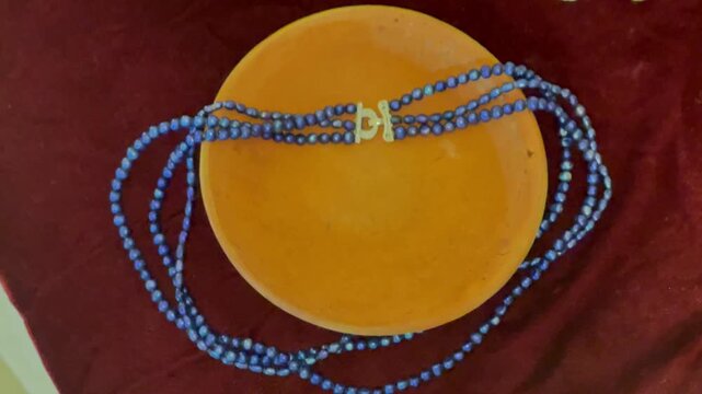 Elegant Multi Strand Blue Beaded Necklace on Yellow Plate Display