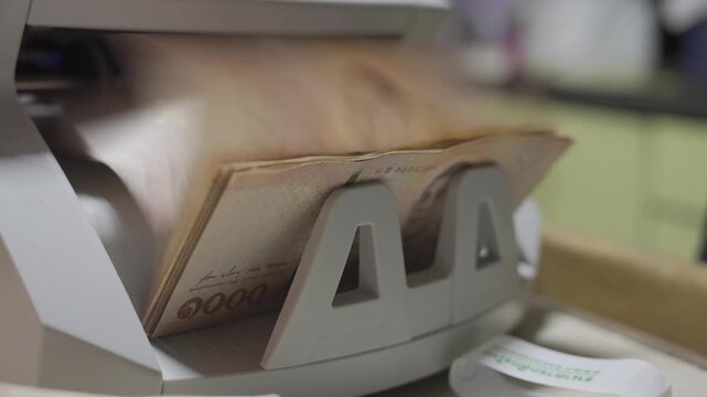 selective focus close up to Money counting machine in motion while bank note were counting action. Banking operation with money Business concept with money. Counting machine for money theme.