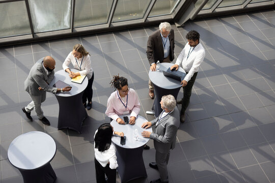 Businessmen and businesswomen talk at a trade fair
