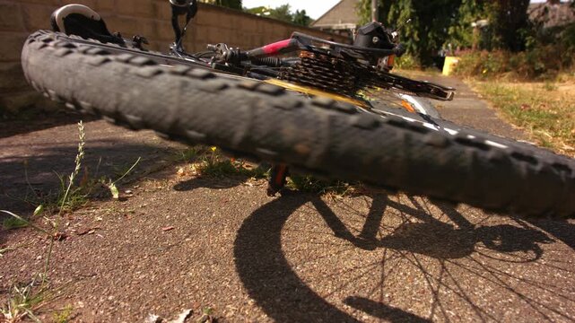 Stationary bicycle wheel turning on pathway