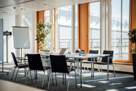 Empty modern meeting room with laptop during a business break