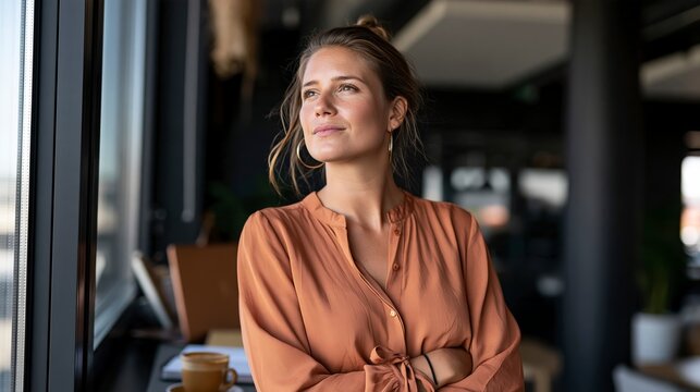 Professional Woman Taking a Quiet Break by Office Window