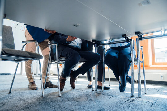 Business colleagues hold a meeting viewed from under the table
