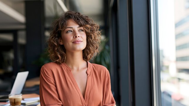 Thoughtful Professional Woman Taking Break by Office Window