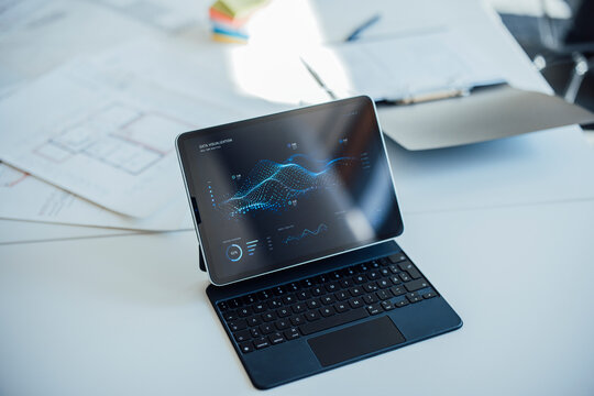 Tablet with data analysis on a desk in a meeting room