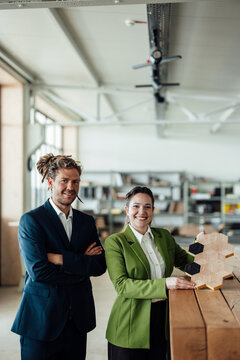 Man and woman present sustainable wood design in the office