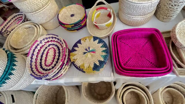 Close-up of Artisanal South Asian Straw Chabbi and Woven Bread Baskets at Folk Festival, traditional artisan craftsmanship and Pakistani cultural heritage.