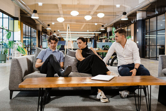Colleagues have an informal meeting in a modern office