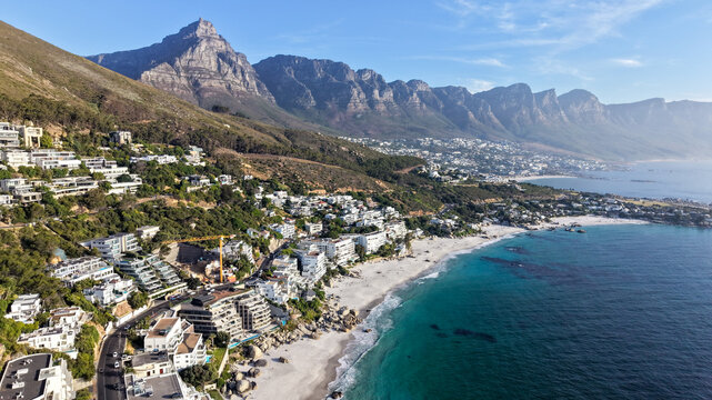Aerial view of Clifton 1st beach with luxury hillside houses and the Twelve Apostles mountain range overlooking the Atlantic Ocean in Cape Town, Western Cape, South Africa.