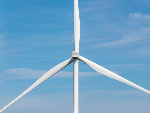 Aerial view of a wind turbine at Parc eolien des trois cantons against a clear blue sky in Etouvans, Bourgogne-Franche-Comte, France.