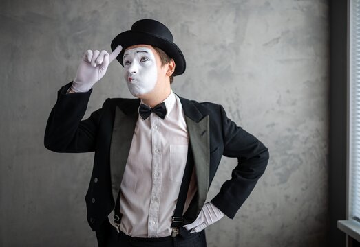 Rear view of a mime artist with hands clasped behind his back